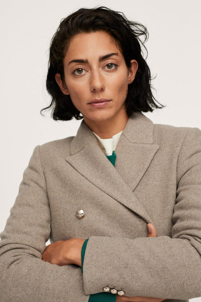Women's taupe blazer with gold button detail and notched lapels
