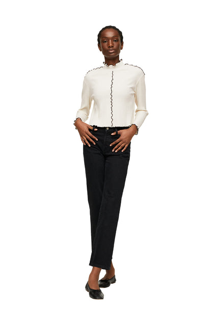 Ecru long-sleeve knit top with stand collar and vertical ruffle trim
