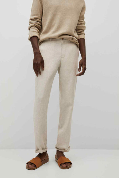 Ecru trousers with relaxed straight legs and cuffs, front button fly.
