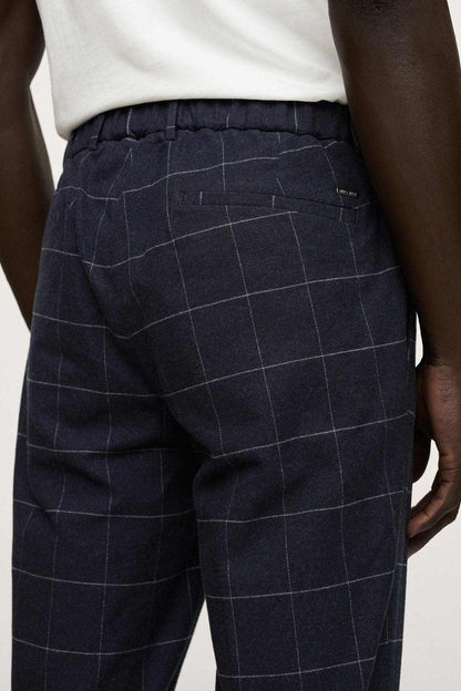 Men's dark navy windowpane check trousers detail: belt loops and pleated front