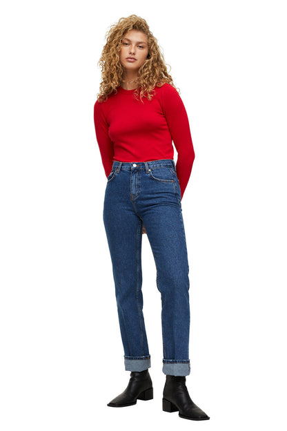 Red long-sleeve crew-neck top, worn with blue straight-leg jeans