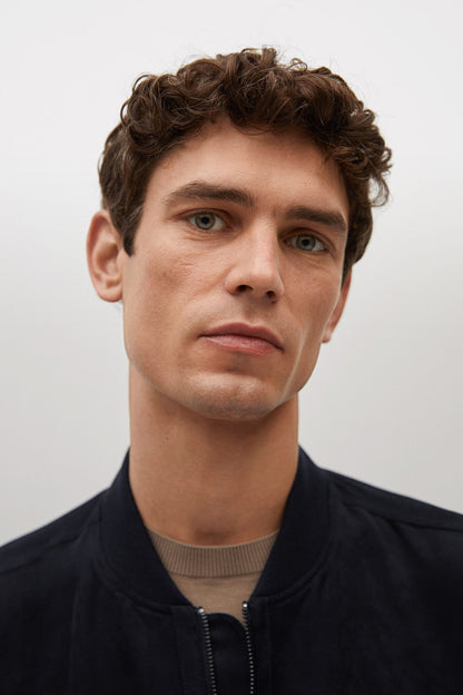 Dark navy jacket close-up, zip and stand collar detail