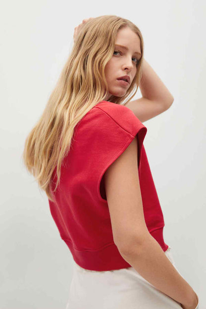 Red cropped sweatshirt, short sleeves, crew neck; side view showing hem and seams