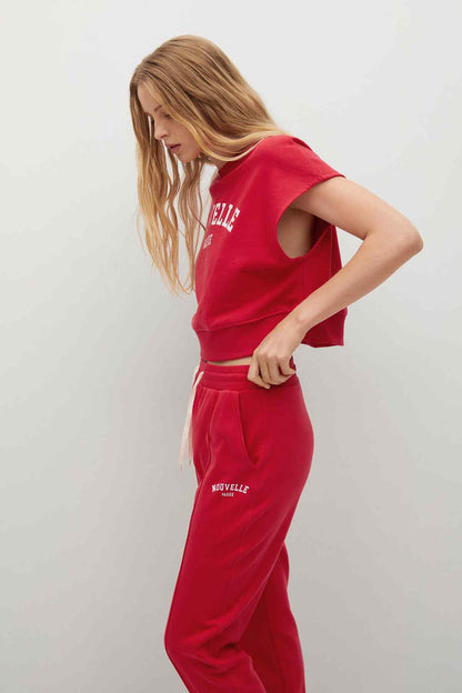 Red cropped short-sleeve sweatshirt with matching jogger pants, graphic text on chest