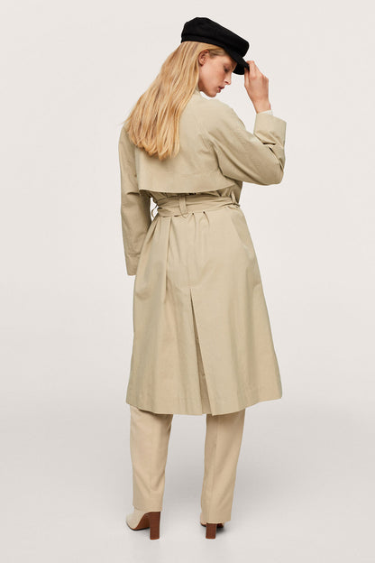 Beige trench coat with waist tie belt and long sleeves, side view