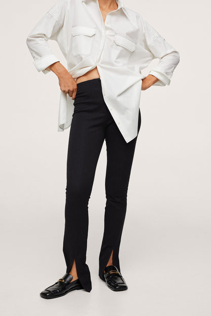 Black slim trousers, front view, with ankle slit and clean seams.