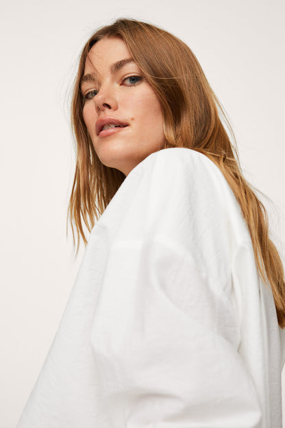 Off-white long-sleeve blouse with gathered cuffs, side view
