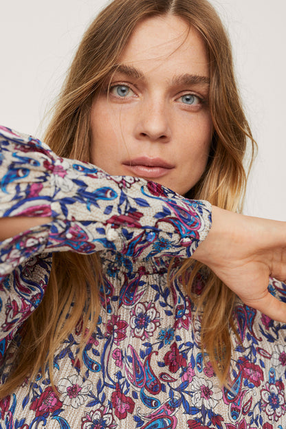 Floral patterned off-white long-sleeve blouse with ruched neckline