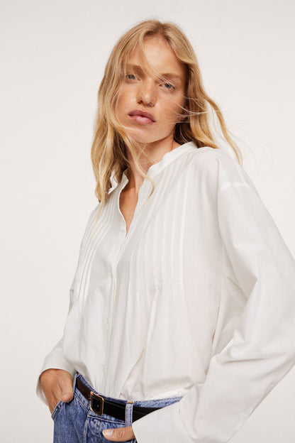White button-up blouse with collar, long sleeves and vertical pleated details