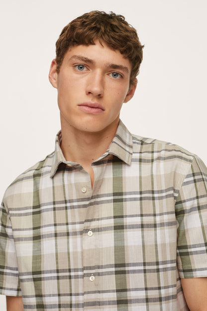 Men’s plaid button-up shirt close-up, short sleeves and buttoned collar.