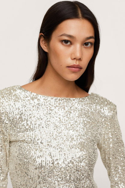 Gold sequin long-sleeve mini dress, round neckline close-up