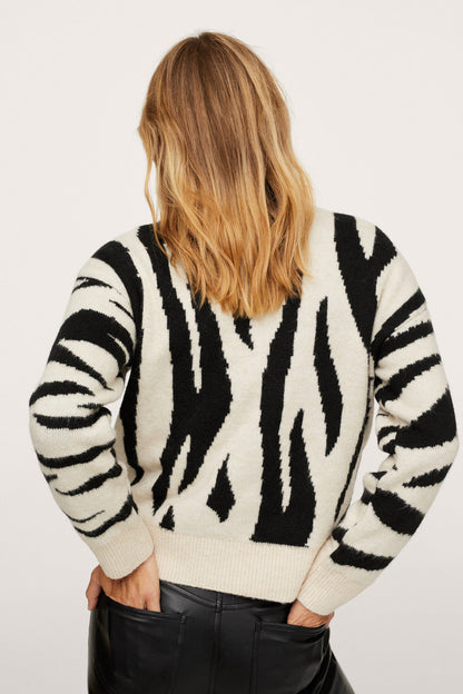 Black-and-white zebra-striped knit sweater with long sleeves, ribbed cuffs and hem