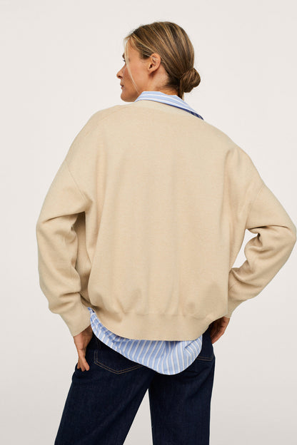 Beige button-front jacket, back view, ribbed cuffs and waistband