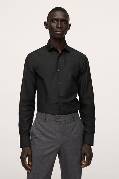 Black button-up dress shirt on model, long sleeves and front placket