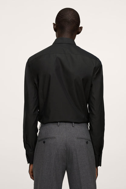 Back view of black button-up dress shirt with long sleeves and yoke
