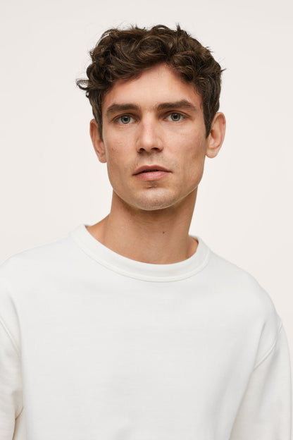 Men's off-white crewneck sweatshirt close-up of neckline and collar