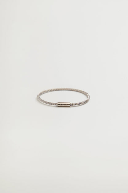 Braided cord bracelet with silver-tone clasp and metal end pieces