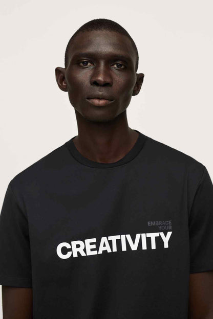 MANGO men's black T-shirt close-up with 'CREATIVITY' and 'EMBRACE YOUR'