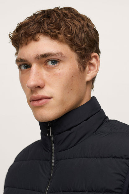 Dark navy puffer jacket close-up with zippered stand collar