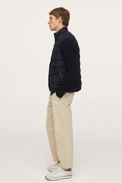 Dark navy quilted puffer jacket side profile with zip front