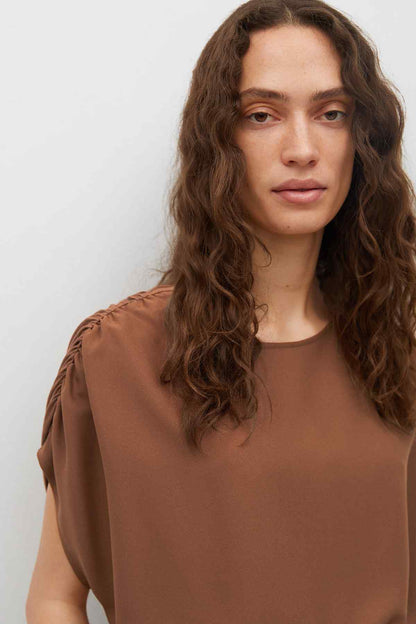 Brown short-sleeve top with round neck and gathered shoulder details