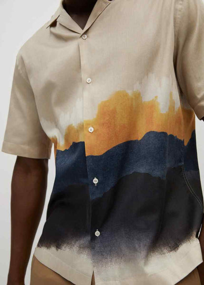MANGO sand button-up shirt close-up with orange and blue landscape print and white buttons