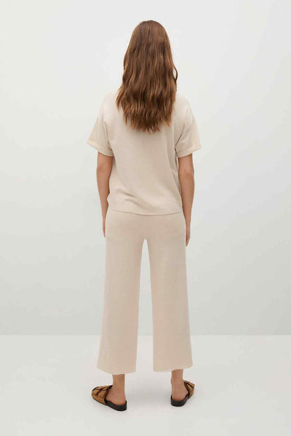 Ecru wide-leg knit culotte pants, back view with center-seam styling