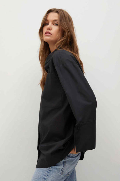 Black jacket with long sleeves and button placket, side view