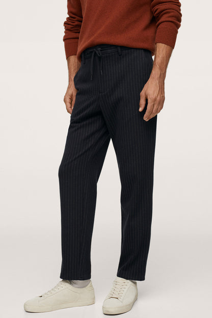 Dark navy pinstripe trousers with drawstring waist and tapered legs