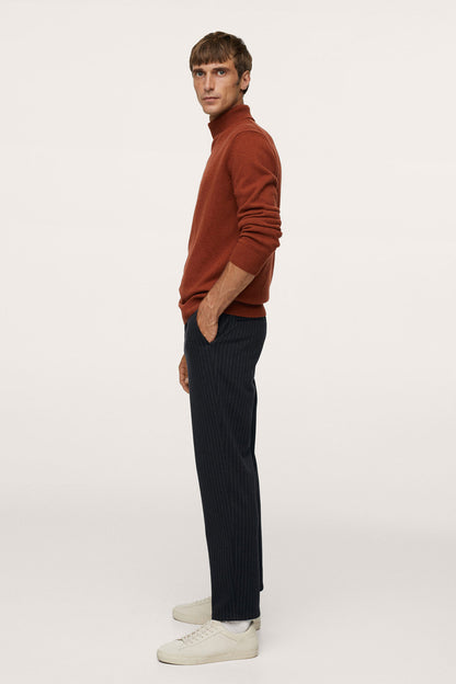 Dark navy pinstripe trousers, side view, tapered fit and ankle-length hem