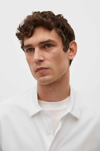 Off-white short-sleeve button-up shirt collar and top button detail