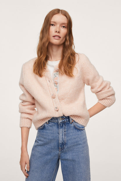 Pastel pink knit cardigan with button placket and puff sleeves, front close-up
