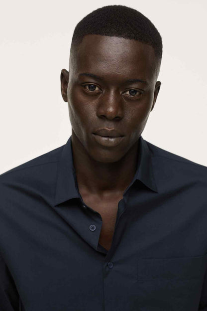 Navy button-up shirt close-up with collar and chest pocket