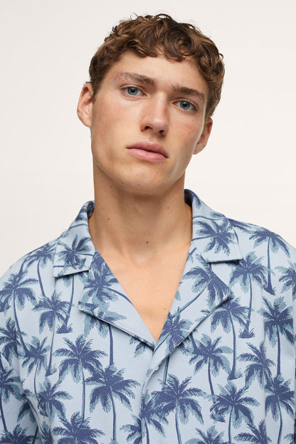 Men’s palm-print short-sleeve button-up shirt with spread collar, chest close-up