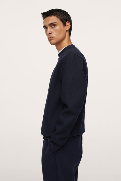 Men's dark navy crewneck sweatshirt, side profile view