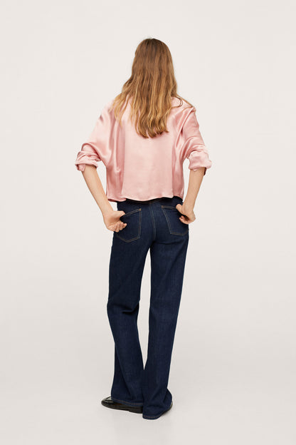 Pink button-up blouse with collar, back view, rolled sleeves, dark flared jeans