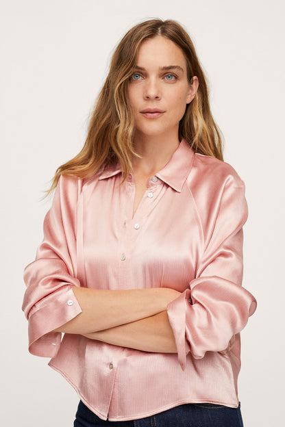 Pink satin button-up blouse with pointed collar and front buttons, rolled sleeves