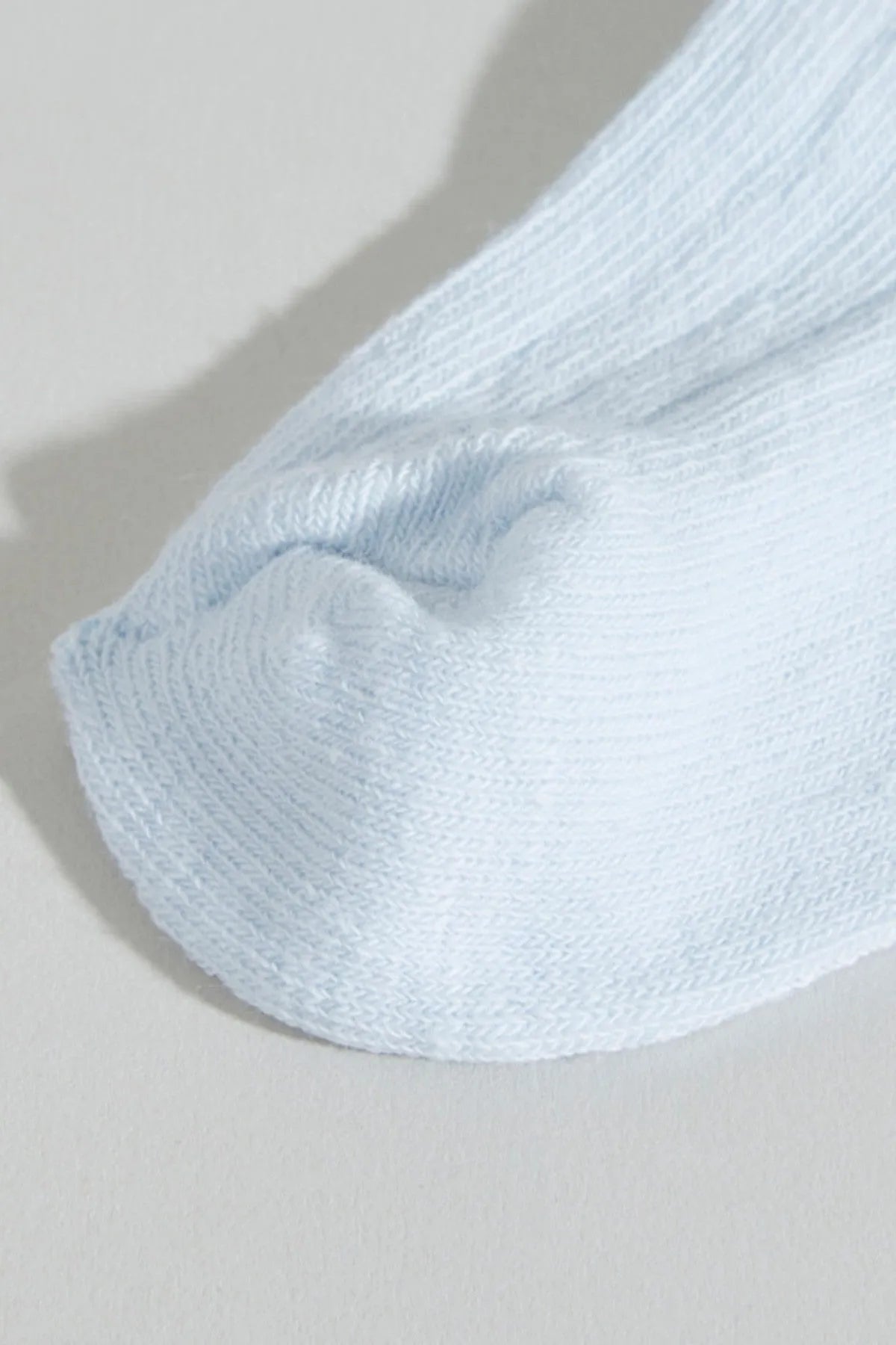 Baby sock, light blue ribbed cuff and knit texture