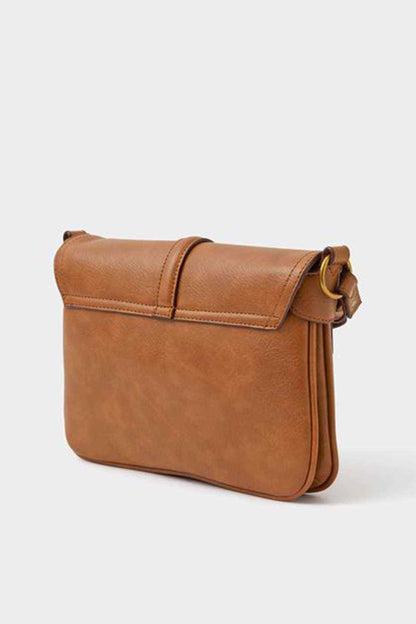Tan crossbody bag with flap and rounded shape, featuring an adjustable strap