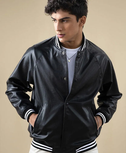 Fitted black leather bomber jacket with snap front and ribbed striped cuffs