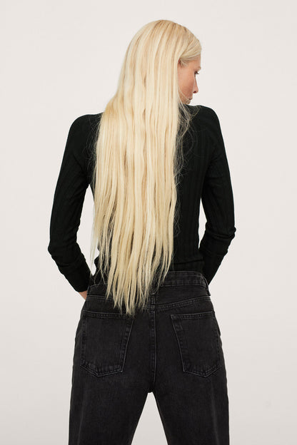Black ribbed turtleneck sweater with black denim jeans, back view