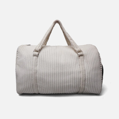 Cream corduroy-texture duffel bag with top handle, side zipper, and adjustable straps