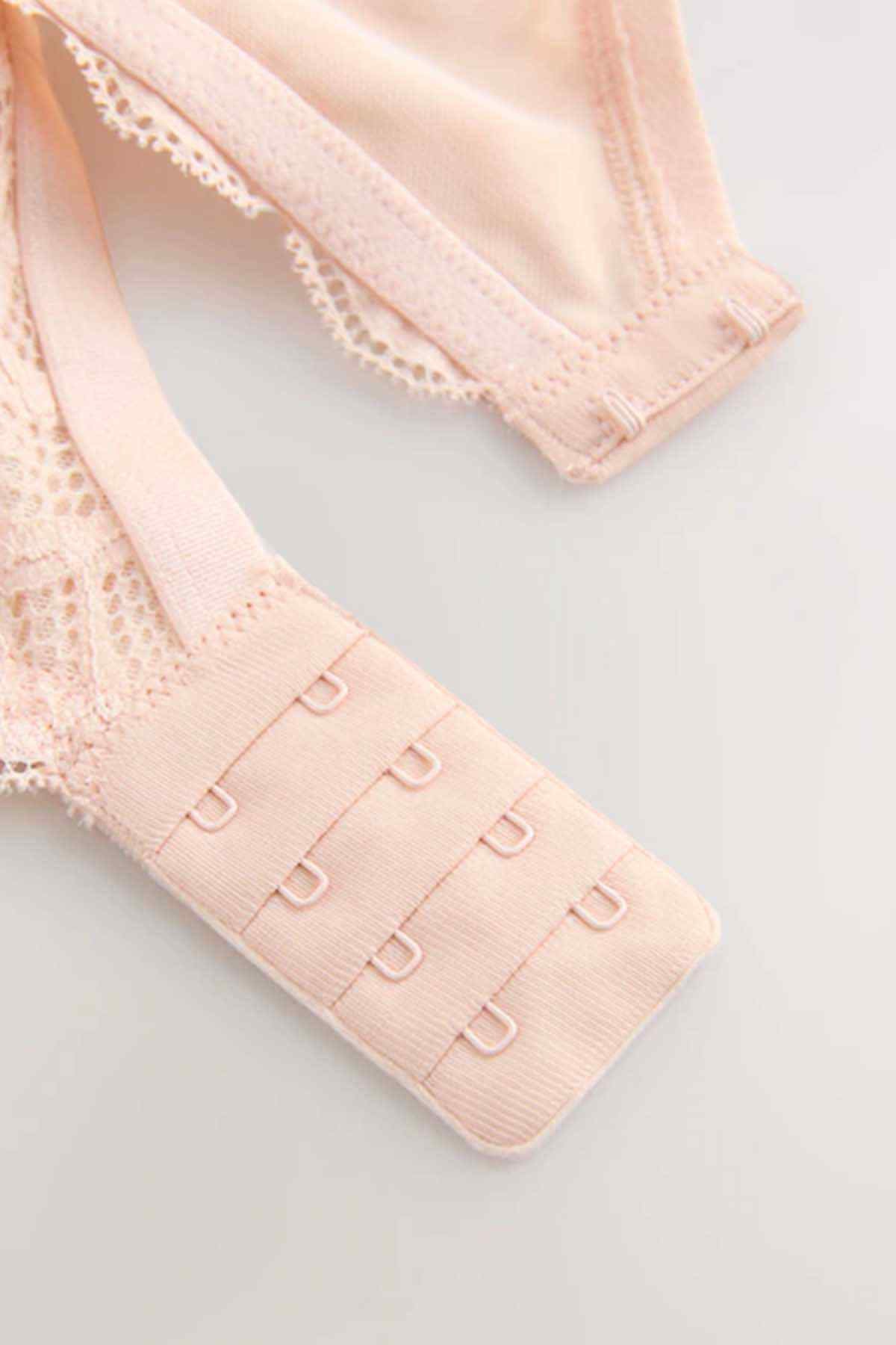 Coral pink lace bra back band with hook-and-eye closure.