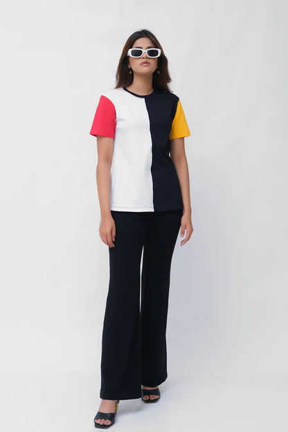 Colorblock T-shirt with white center, black sides, red and yellow sleeves; black wide-leg pants