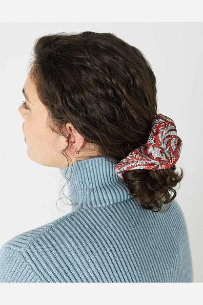 Red paisley fabric hair scrunchie worn in brown hair bun