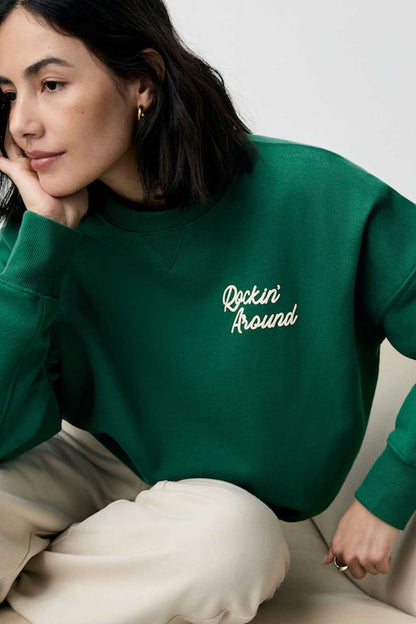 Forest green sweatshirt with 'Rockin' Around' chest graphic and long sleeves