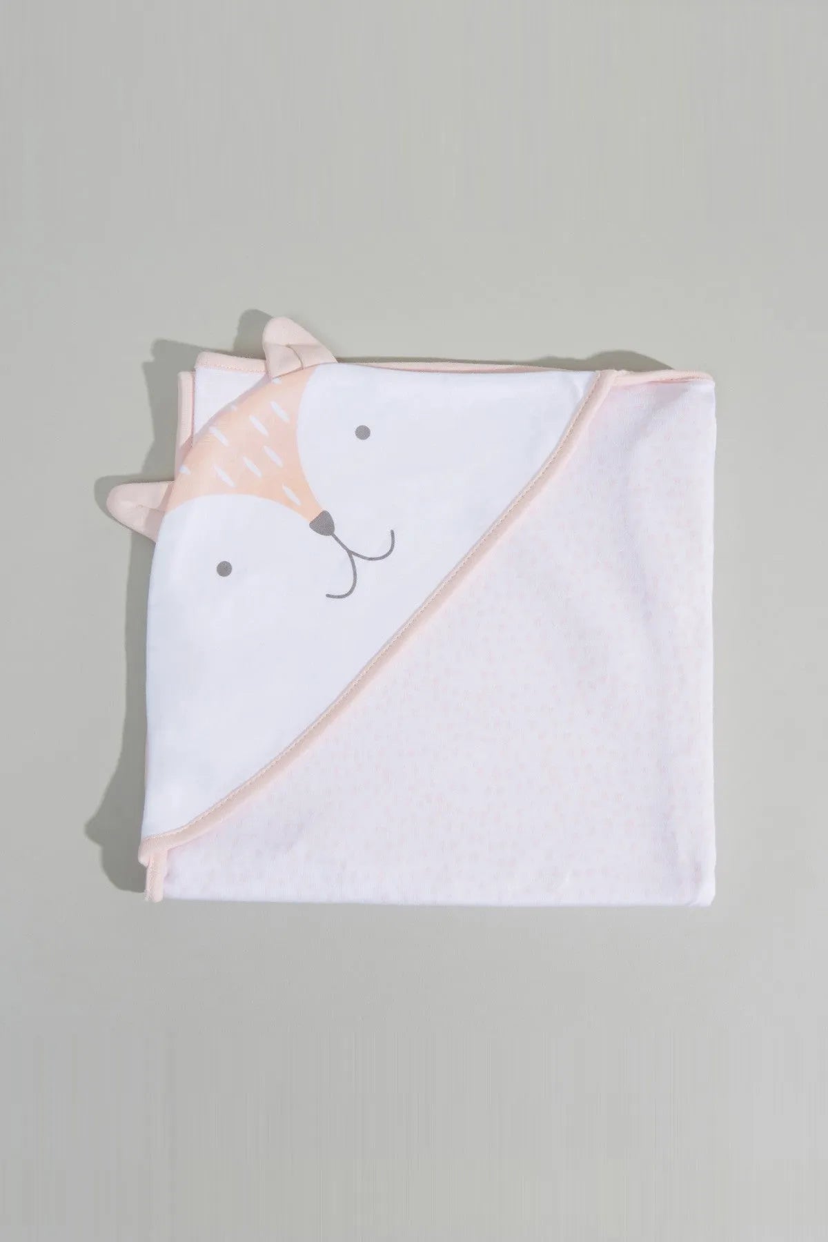 Folded hooded baby towel with rabbit design, white with peach trim and pink accents