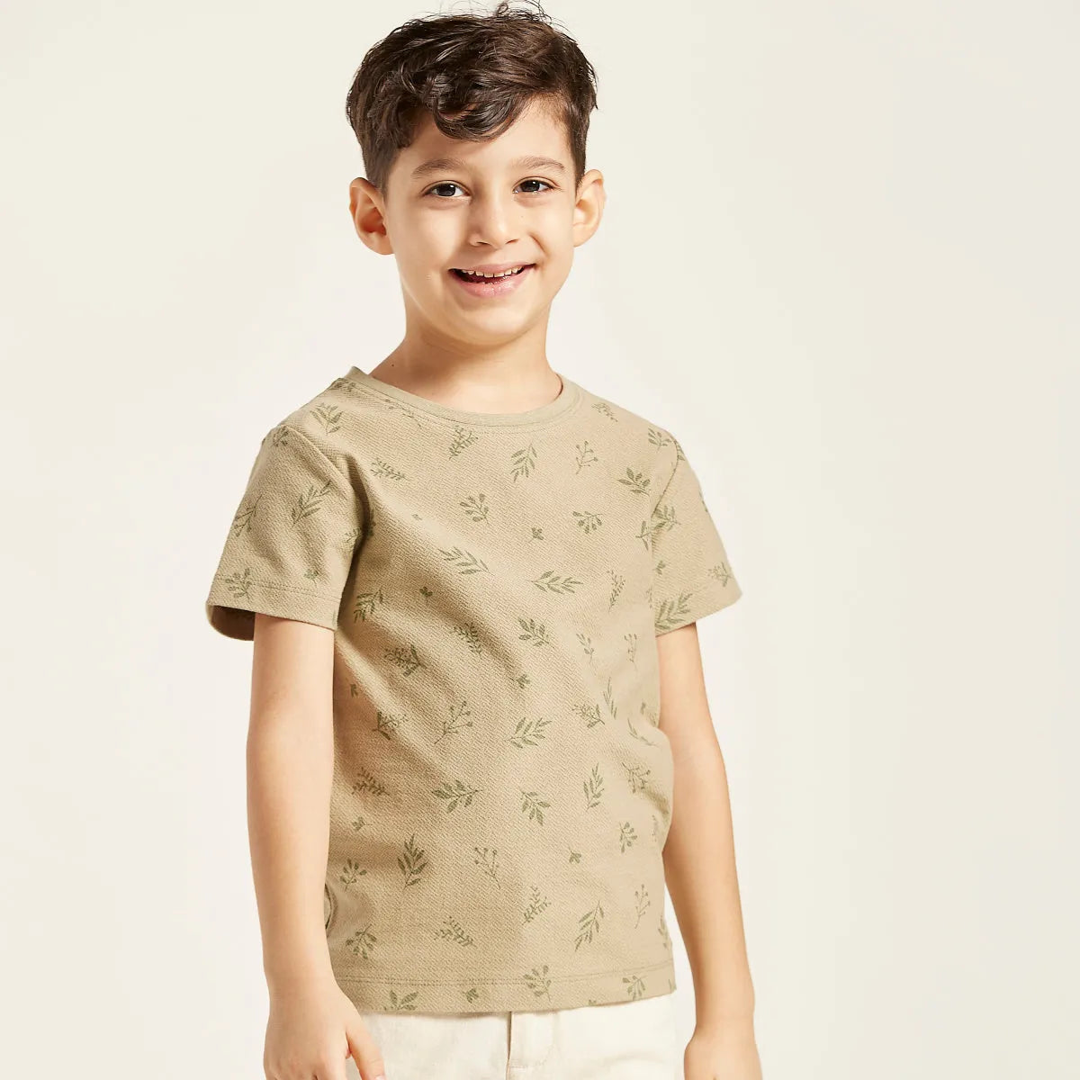 Kids T-shirt, tan with small green leaf print and short sleeves