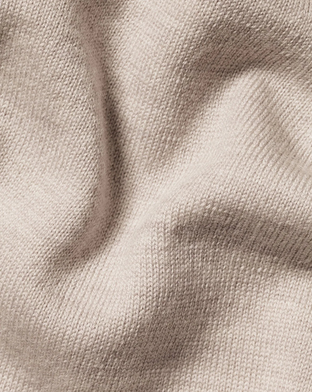 Beige knit sweater fabric close-up