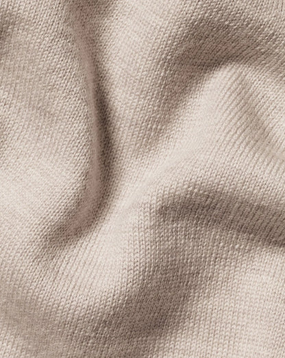 Beige knit sweater fabric close-up